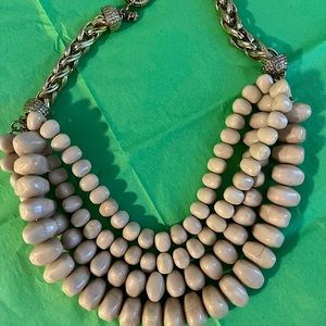Beautiful BR multi layered light almond colored flat bead necklace.